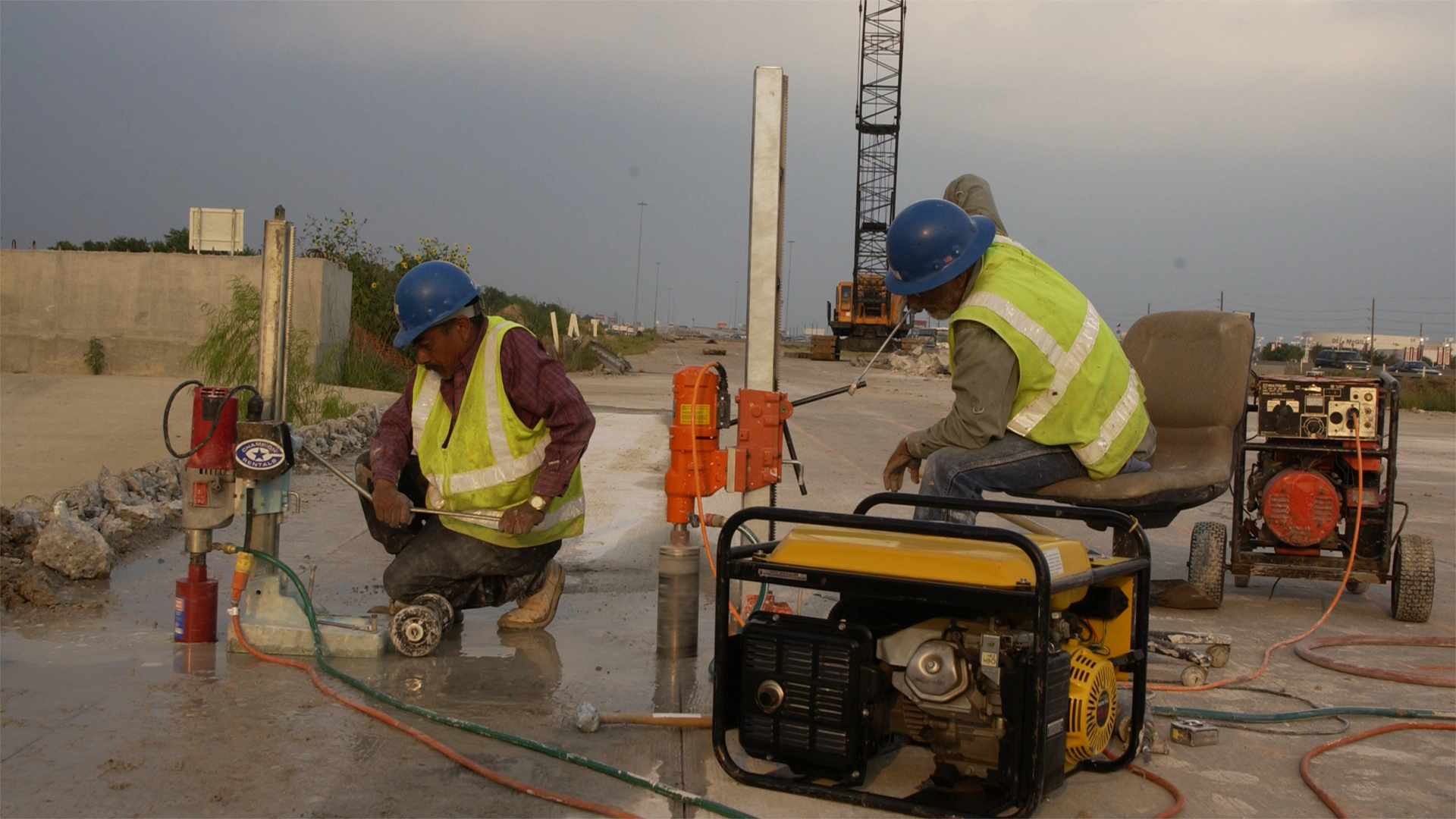 Workers using coring drills with generators