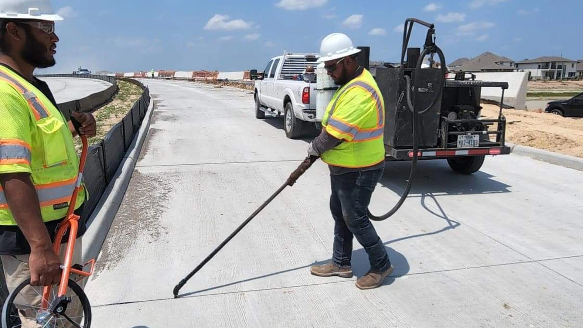 Worker injecting sealant into concrete joint