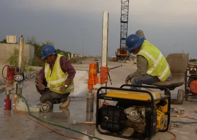 Workers using coring drills with generators