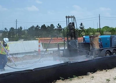 Worker cleaning expansion joint with compressor trailer