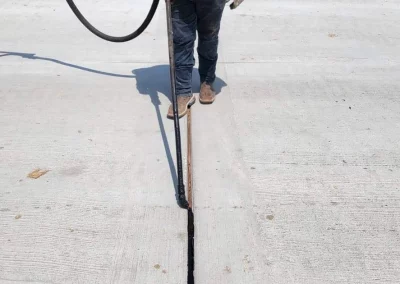 Worker putting sealer on Expansion Joints