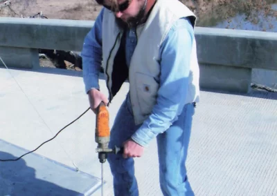 closeup of worker mixing epoxy in pail