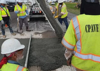 Workmen pouring concrete