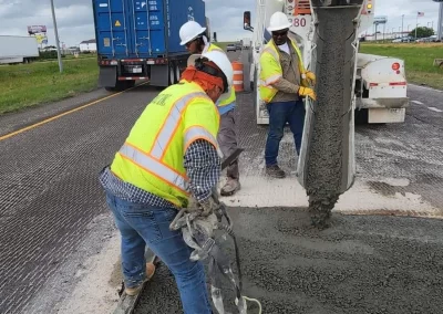 Workman pouring concrete for roadway repair